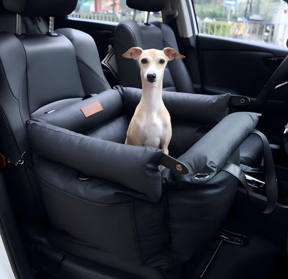 A small Italian Greyhound sitting securely in a black multifunctional pet car seat carrier installed in a car, featuring high-sided crash protection, non-slip bottom, and secure straps, ideal for safe road trips and outdoor adventures.