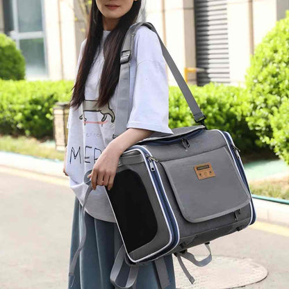 A grey convertible pet carrier worn as a shoulder bag, designed to seamlessly switch between bike basket, backpack, and hand-held modes, eliminating the need for multiple bags when moving from cycling to hiking.