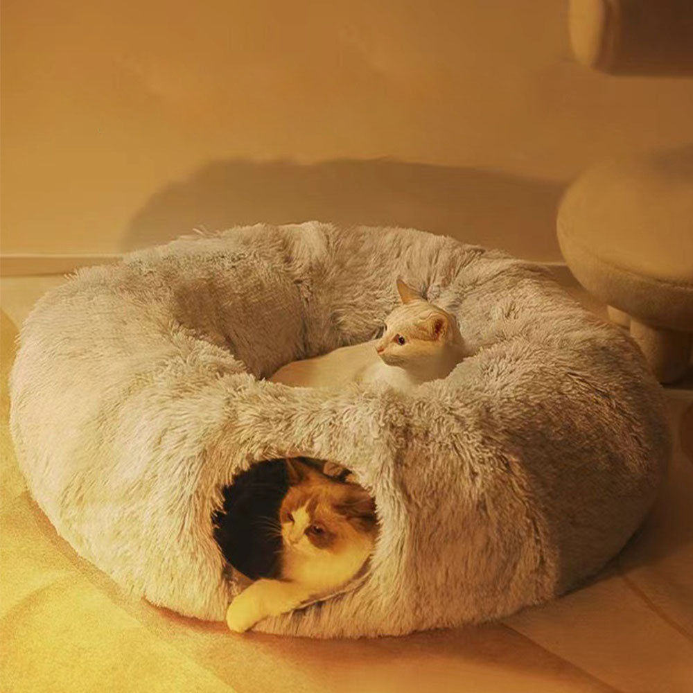 Grey donut cat bed tunnel with two cats relaxing in warm lighting – a calming solution to ease nighttime anxiety, providing a secure den-like environment for your cats to rest and bond.