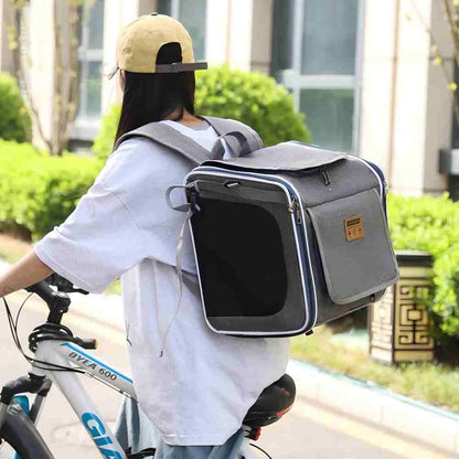 A grey multi-functional pet carrier worn as a backpack during cycling, allowing pet owners to keep hands free while ensuring pets are securely contained with breathable mesh panels and stable straps for outdoor adventures.
