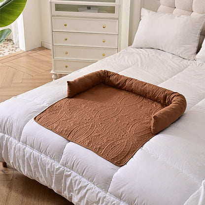 Brown semi-enclosed pet mat placed on a white bed, demonstrating versatile use as a bed mat, sofa protector, or car seat cover, with a cozy raised edge for neck support and decor-friendly design
