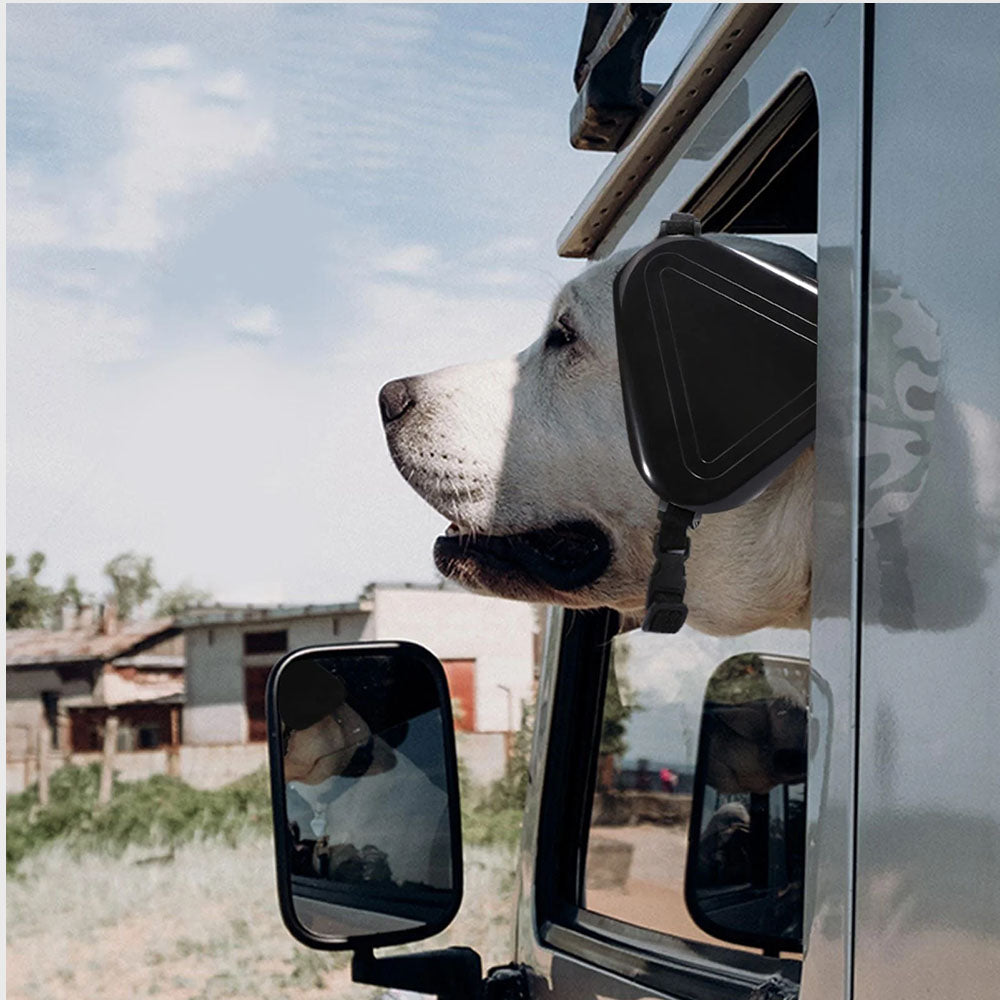A large white dog wearing pet noise canceling earmuffs, sticking its head out of a car window—protects from traffic noise/wind while keeping comfortable, ideal for noise-sensitive pets during outdoor rides.