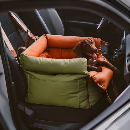  happy brown dog sitting securely in an olive green and orange multifunctional pet car seat carrier installed in a car, emphasizing safe travel, crash protection, and cozy comfort for pets during drives.