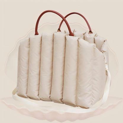 Beige padded pet carrier with leather handles and detachable shoulder strap, blending style and portability for pet owners