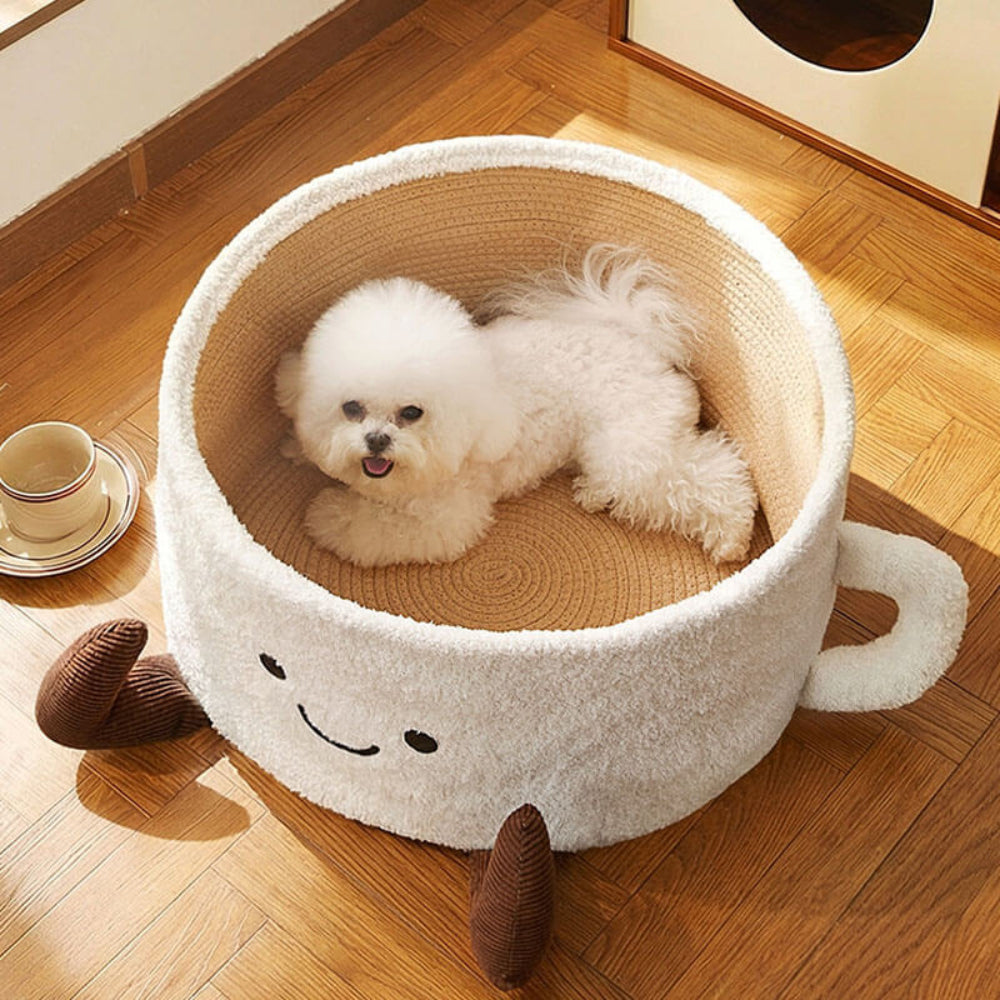 Cute small white dog relaxing inside teacup pet bed, showing the versatile design that works for both cats and small dog breeds as a cozy play and sleep space.