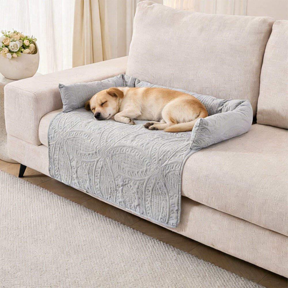 Ultrasonic calming pet sofa mat with semi-enclosed neck support, all-season breathable fabric, non-slip bottom, protecting light-colored sofa while a golden retriever sleeps comfortably on it, ideal for dogs and cats