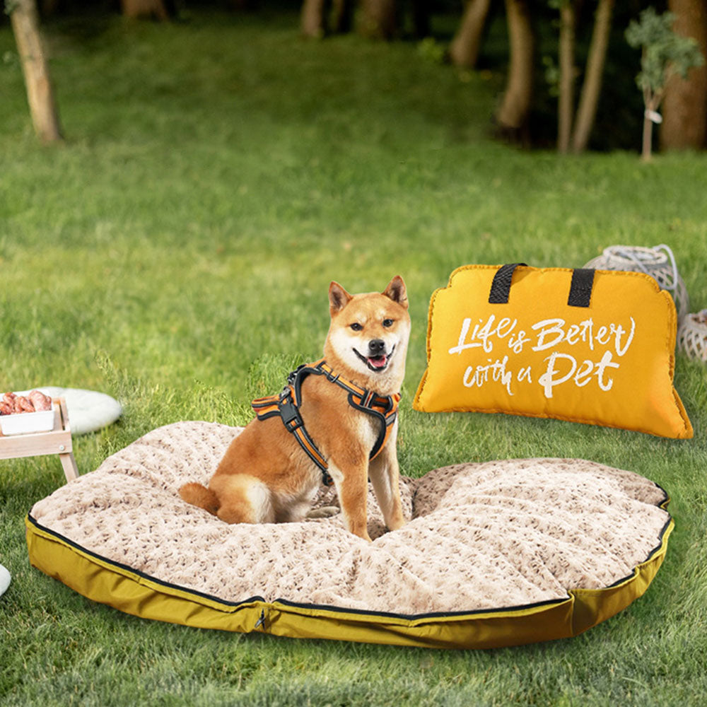 Shiba Inu resting on a plush, waterproof dog bed mat on a grassy lawn, with a yellow "Life is Better with a Pet" carry bag beside it, ideal for camping, hiking, and outdoor adventures.