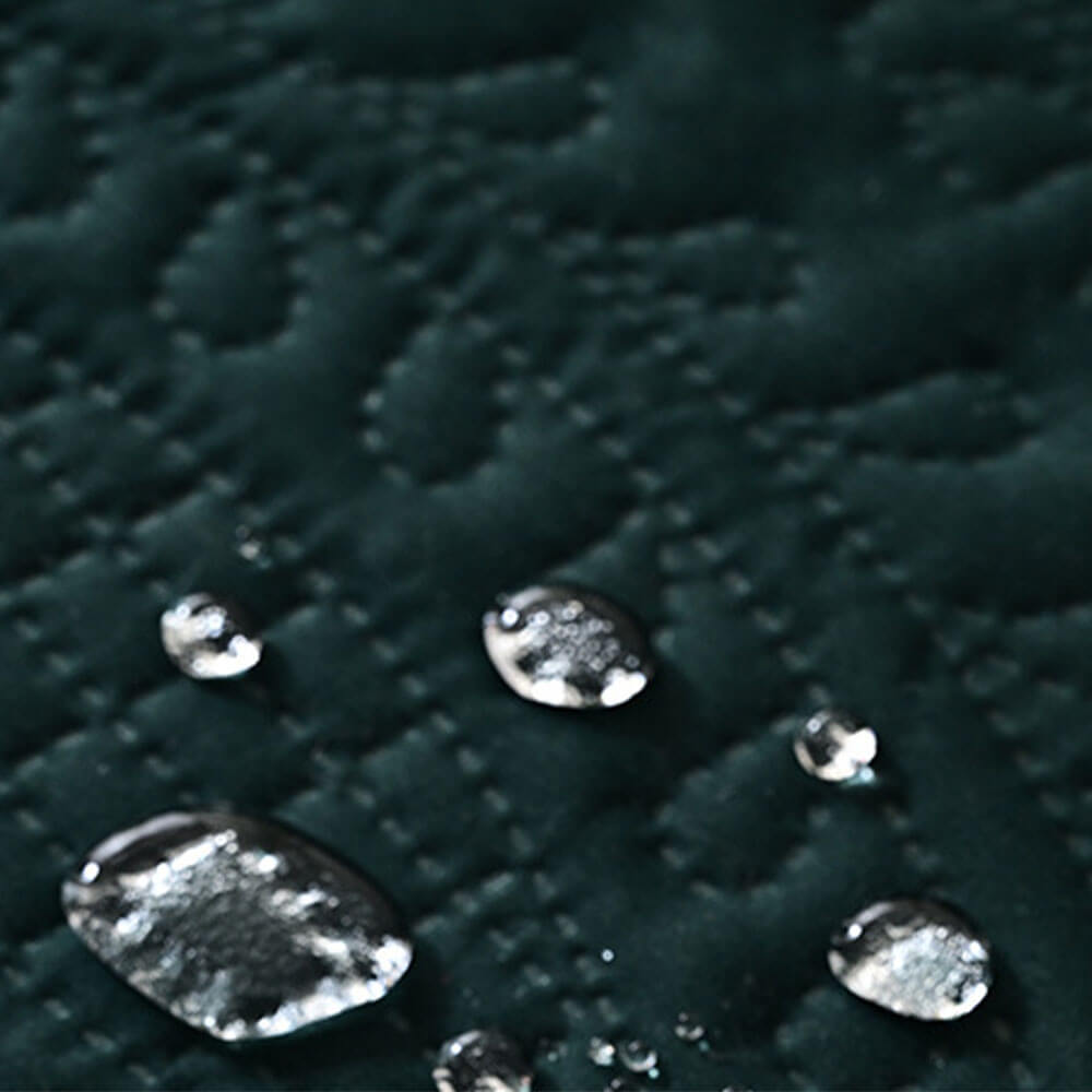 Close-up of water droplets beading on the dark green pet mat surface, demonstrating waterproof and stain-resistant properties to protect against spills, accidents, and pet messes
