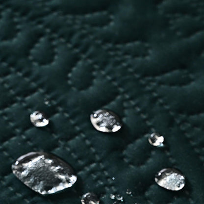 Close-up of water droplets beading on the dark green pet mat surface, demonstrating waterproof and stain-resistant properties to protect against spills, accidents, and pet messes
