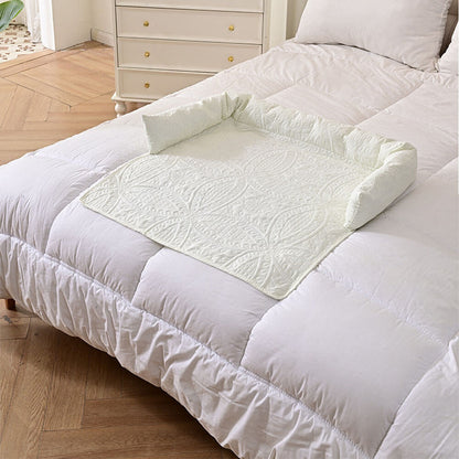 white semi-enclosed pet mat with soft quilted texture and raised neck support edges, placed on a white bed, highlighting breathable all-season fabric and compatibility with sofas, beds, and car seats
